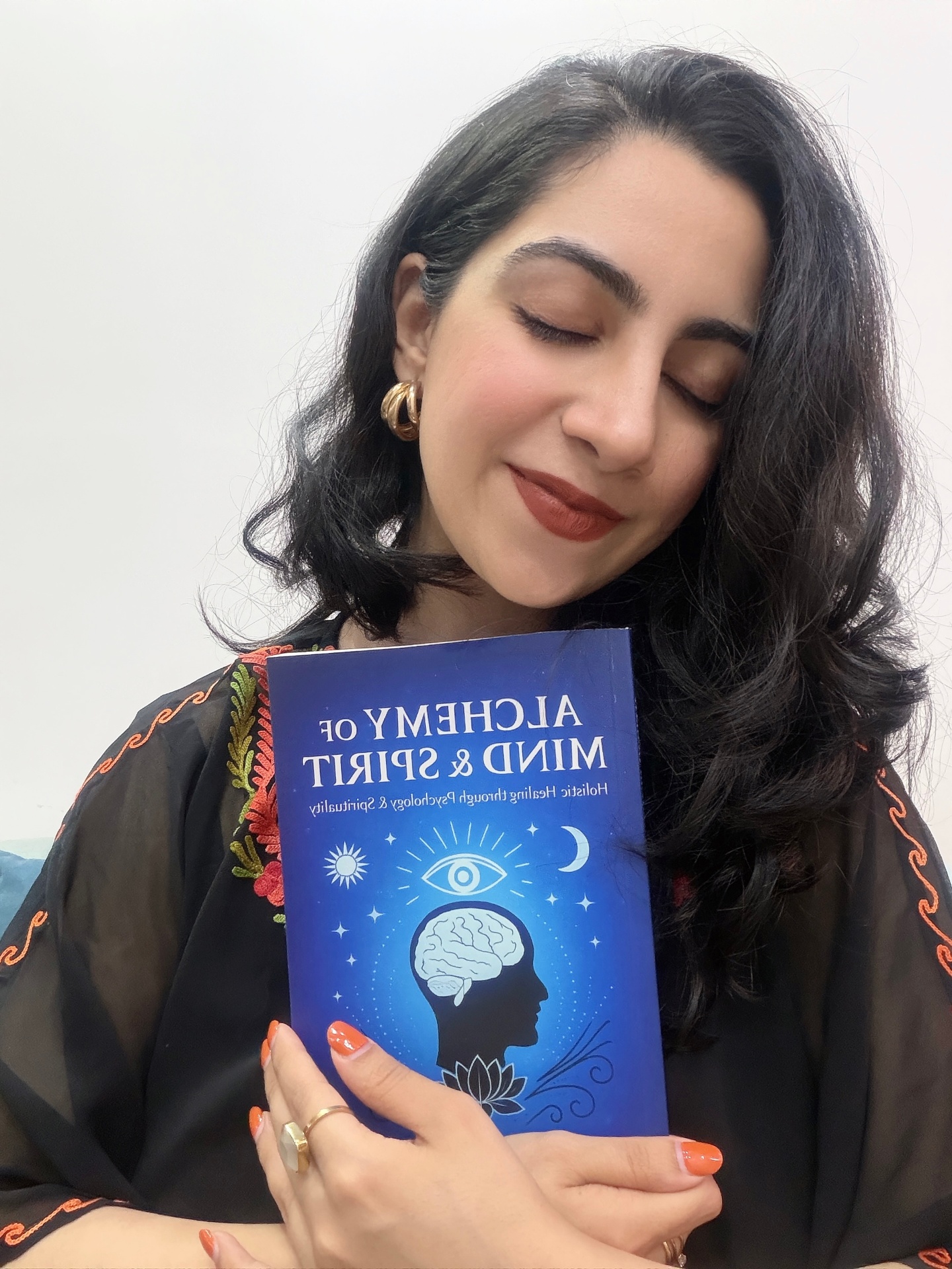 Dr. Vasudha with her book, The Alchemy of Mind & Spirit